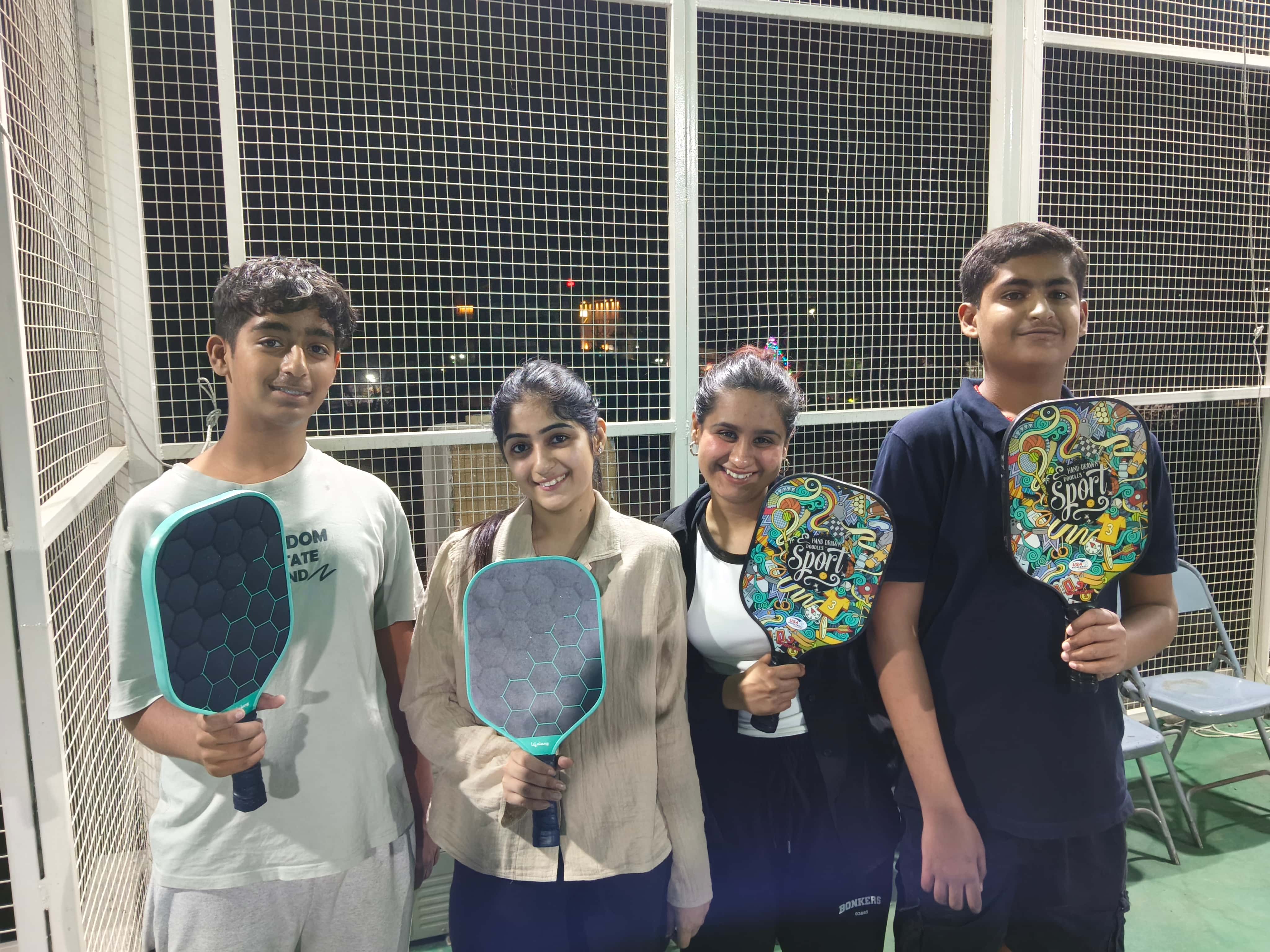 Young players at Shah Pickleball Court holding paddles — coaching sessions for all ages